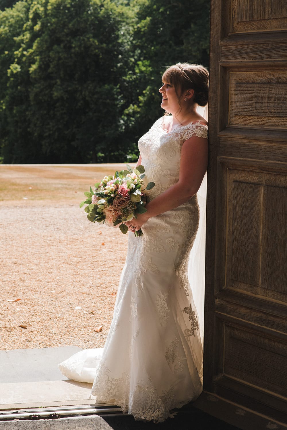Bride leaning on a door