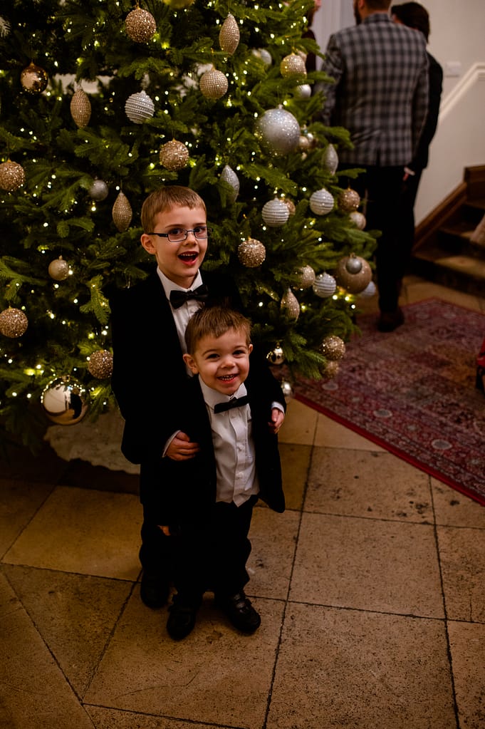 2 boys in front of the Christmas tree
